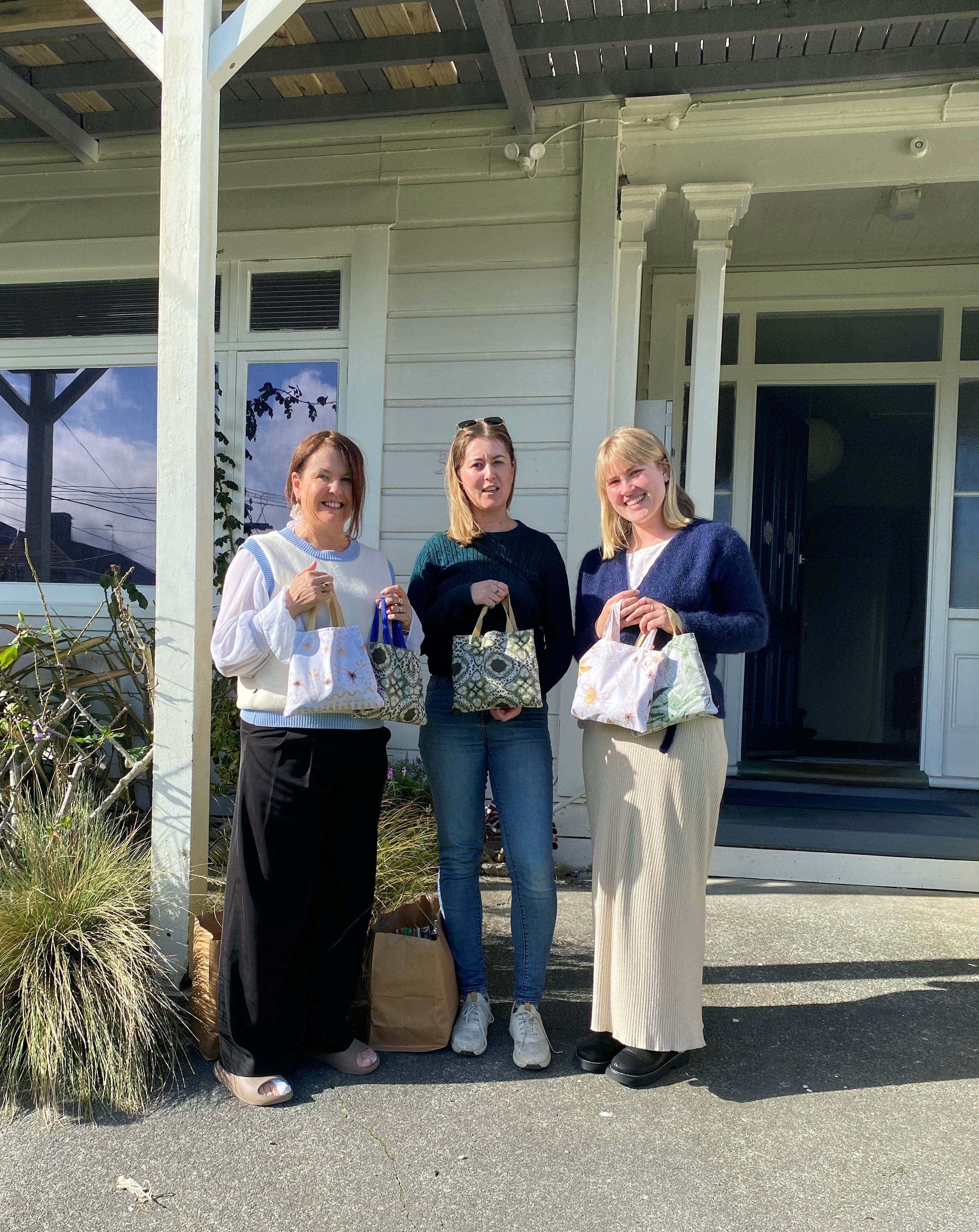 Kate, Natalie, and Ebba with gift bags donated by Altrusa Ohariu.