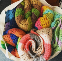 A bag filled with donated crochet blankets