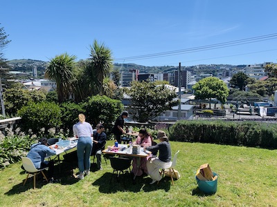 People gathered round a table in a garden