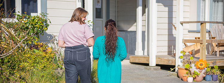 2 women walking up to the House